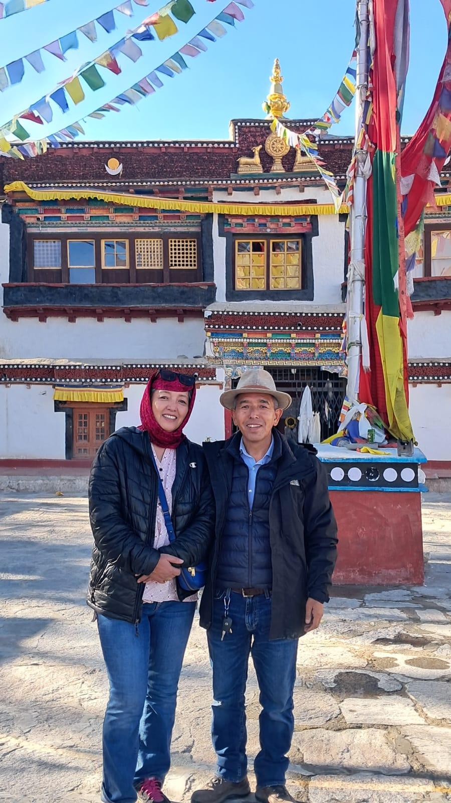 Vinod Kumar, Doksa's owner, and family at a monastery hung with prayer flags